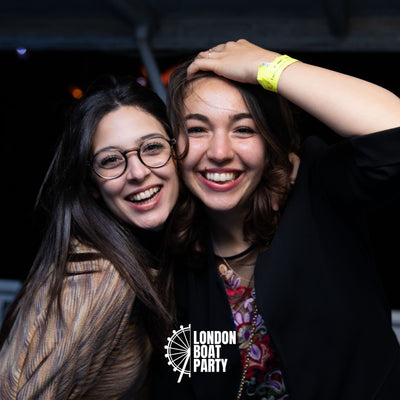 Friends on a boat party in London River Thames